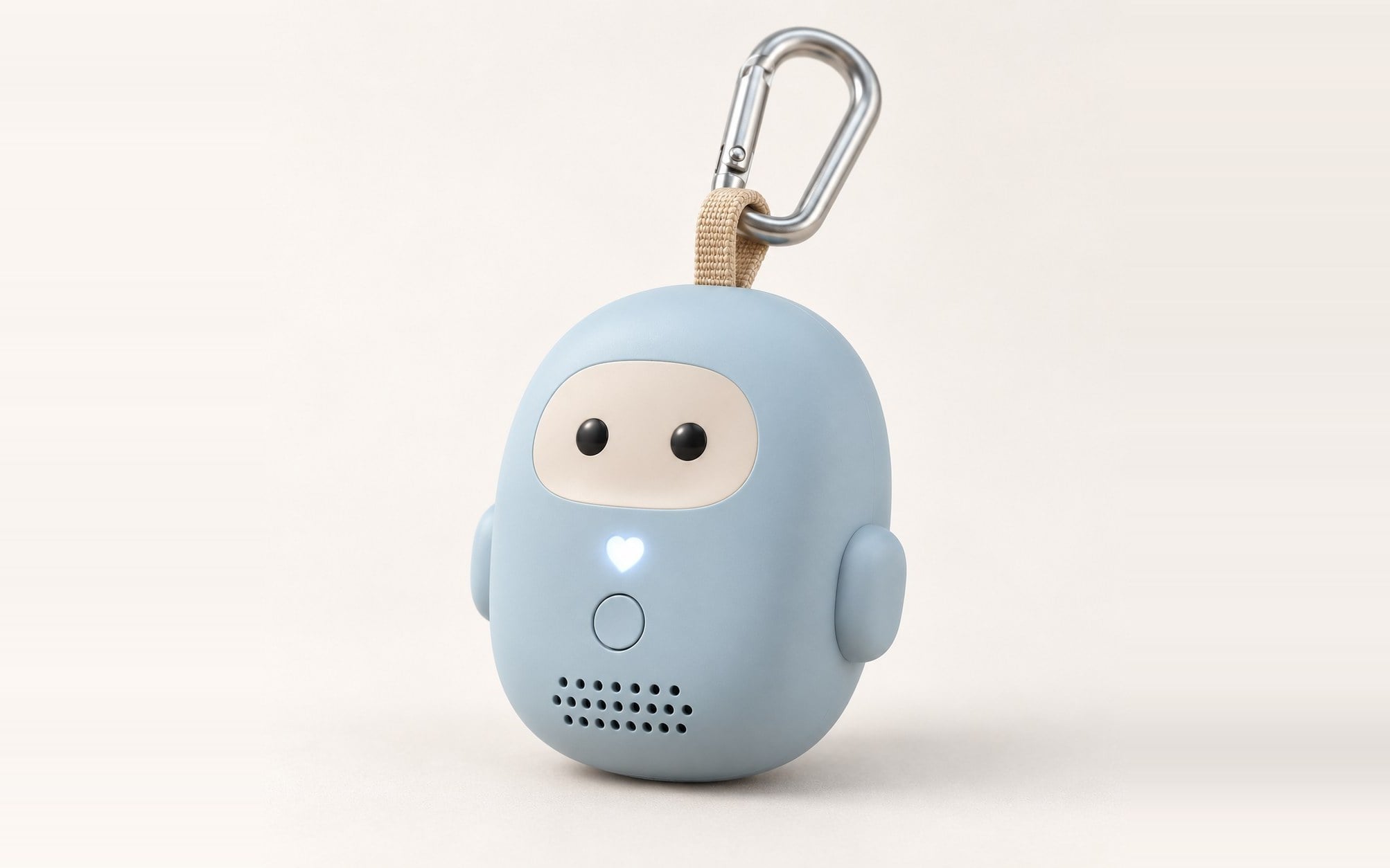 Render of Hamrah from the front: a small, rounded powder-blue toy with a cream face, two dark eyes, small arms and a white heart motif, hanging from a fabric loop and a carabiner